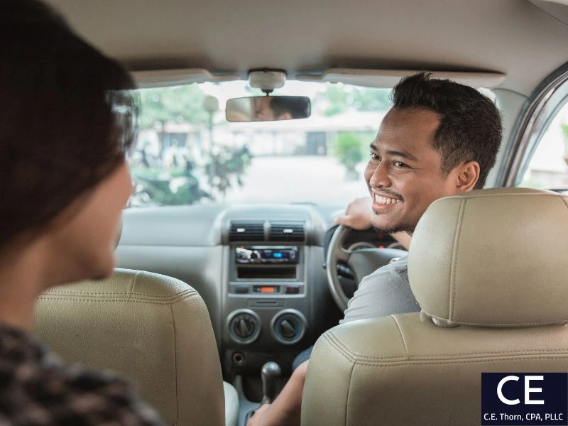 Uber driver with a passenger. Image goes with the question "can i claim uber rides to work on my taxes?"