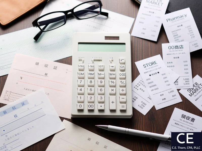 Calculator and receipts. Image accompanies the question "can i write off lyft rides to work?"