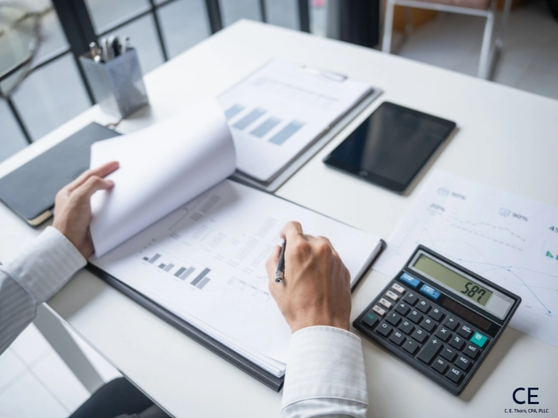 Accountant auditing financial statements. how much does it cost to file taxes, average cost of tax preparation for individual, tax preparer near me, cost to file taxes, tax preparation fees, tax preparation price list. 